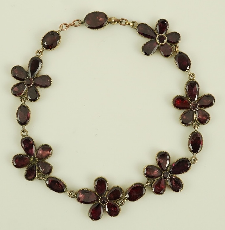 An early Victorian gold and foil backed garnet cluster set bracelet